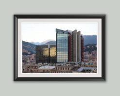 A gigantic structure with glass facades reflects the heart of the city, a mixture of history, sunrays and a serene blue sky.