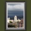 Wooden framed artwork by Travel Photographer Scott Allen Wilson, showcasing a bright white domed tower uplifting towards dark cloudy skies.