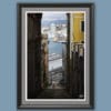 Wooden framed artistic print of a breathtaking portrait shot, showcasing an alley leading down towards the port, while tall buildings frame the image on every side.