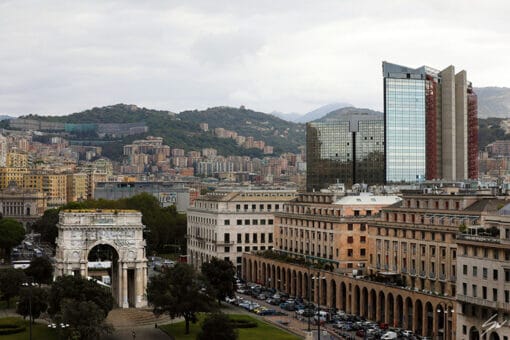 Patches of vegetation surround this rich cityscape, where a few monumental structures rise proudly. Photo captured in Genova, by Travel Photographer Scott Allen Wilson.