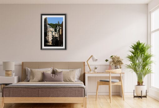 The golden colors of the sunlit houses in this shot, as well as the vibrant green colored trees, pair flawlessly with the beige and sandy colors of the room.