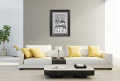 The grayscale composing the sky in this marvellous image seems to exit the frame to continue its way around the walls of this living room, furnished with a black and white decor which resembles the facades and roofs of the buildings in the picture.