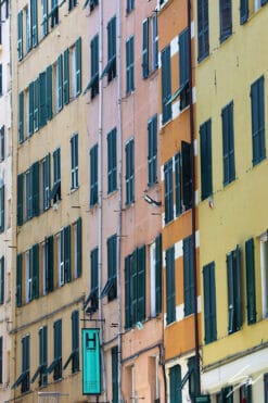 Zoomed detail of a residential facade, a blend of bright colors and dark windows. Photo captured by Travel Photographer Scott Allen Wilson